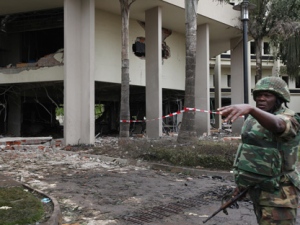 A soldier gesture at the bombed site of the United Nations' office Saturday, Aug 27, 2011, after a car blew up in Abuja, Nigeria. (AP Photo/Sunday Alamba)