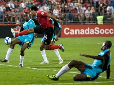 Canada's Dwayne De Rosario, centre, fails to connect with a cross as St. Lucia's Fabian Joseph, left, looks on during first half 2014 World Cup Qualifying game action in Toronto on Friday September 2, 2011. THE CANADIAN PRESS/Chris Young