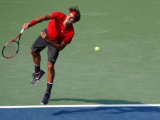 Roger Federer of Switzerland serves to Marin Cilic of Croatia during the U.S. Open tennis tournament in New York, Saturday, Sept. 3, 2011. (AP Photo/Mel Evans)