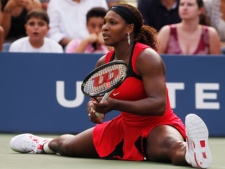 Serena Williams sits on the court following a shot to Victoria Azarenka of Belarus during the U.S. Open tennis tournament in New York, Saturday, Sept. 3, 2011. (AP Photo/Mike Groll)