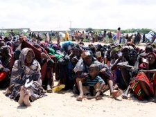 Somalis wait for food aid to be handed out from the UNHCR in Mogadishu on Wednesday, Aug. 31, 2011. (AP Photo/Khalil Senosi)