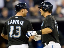 Toronto Blue Jays J.P. Arencibia, right, and Brett Lawrie celebrate Arencibia's two-run home run in the second inning of MLB baseball action against the Boston Red Sox in Toronto Wednesday, September 7, 2011. Arencibia set a new Blue Jays record for home runs by a catcher with his 21st of the season. (THE CANADIAN PRESS/Darren Calabrese)