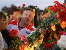 Fans of the Lokomotiv ice hockey team lay flowers and light candles at the Lokomotiv Arena to pay tribute to the Lokomotiv players killed in a plane crash, in the city of Yaroslavl, on the Volga River about 150 miles (240 kilometers) northeast of Moscow, Russia, Wednesday, Sept. 7, 2011. The Yak-42 jet carrying the Lokomotiv ice hockey team crashed while taking off Wednesday near Yaroslavl. It was one of the worst plane crashes ever involving a sports team. (AP Photo/Misha Japaridze)