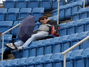 A tennis patron falls asleep in the stands during a rain delay at the U.S. Open tennis tournament in New York, Wednesday, Sept. 7, 2011. (AP Photo/Charlie Riedel) 