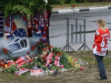 A Lokomotiv Yaroslavl fan stands outside the ice hockey arena in Yaroslavl, Russia, Thursday, Sept. 8, 2011. The team's players were killed in a plane crash in Yaroslavl, on the Volga River about 240 kilometres northeast of Moscow, Russia on Wednesday, Sept. 7, 2011. (AP Photo/Misha Japaridze)