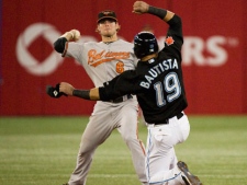 Toronto Blue Jose Bautista gets caught out on second by Baltimore Orioles Ryan Adams during fourth inning MLB action in Toronto Friday September 9, 2011. (THE CANADIAN PRESS/Aaron Vincent Elkaim)