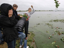 People gather to mourn the victims of Wednesday's crash near Yaroslavl, 150 miles (240 kilometers) northeast of Moscow in Russia, Friday, Sept. 9, 2011. Russian air accident investigators began examining recorder boxes Friday from a plane that crashed earlier this week, killing 36 players, coaches and staff of the Lokomotiv Yaroslavl ice hockey team, including European national team and former NHL players. The team had been heading to Minsk, Belarus to play its opening game of the Kontinental Hockey League season. (AP Photo/Misha Japaridze) (AP Photo/Misha Japaridze)