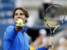 Rafael Nadal of Spain hits a ball into the stands after winning a quarterfinal match against Andy Roddick at the U.S. Open tennis tournament in New York, Friday, Sept. 9, 2011. (AP Photo/Matt Slocum)