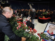 Russian Prime Minister Vladimir Putin lays flowers during a memorial ceremony for the victims of the Russian plane crash in the Arena in Yaroslavl, 150 miles (240 kilometers) northeast of Moscow in Russia, Saturday, Sept. 10, 2011. The sign on the photo says Andrei Zimin. The chartered Yak-42 jet crashed Wednesday into the banks of the Volga River moments after takeoff from an airport near Yaroslavl. The crash killed 43 people, including 36 players, coaches and staff of the Lokomotiv Yaroslavl ice hockey team, many of whom were European national team and former NHL players. It was one of the worst aviation disasters ever in sports, shocking Russia and the world of hockey. The team had been heading to Minsk, Belarus to play its opening game of the Kontinental Hockey League season. (AP Photo/RIA Novosti, Alexei Nikolsky, Pool) 