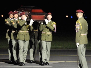 Soldiers carry a coffin with relics of one of three Czech hockey players killed in a plane crash after their arrival in Prague, on Saturday, Sept. 10, 2011, The Yak-42 jet carrying the Lokomotiv Yaroslavl ice hockey team crashed while taking off Wednesday near Yaroslavl, on the Volga River about 150 miles (240 kilometers) northeast of Moscow, Russia, killing 43 people. (AP Photo/CTK, Michal Kamaryt) - 