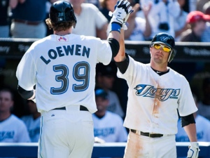 Toronto Blue Jays Adam Loewen is congratulated by Mike McCoy after hitting a home run against the Baltimore Orioles during seventh inning MLB action in Toronto on Sunday September 11, 2011. THE CANADIAN PRESS/Aaron Vincent Elkaim