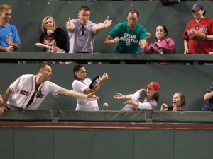 Fans in the Green Monster seats reach for teh ball on a home run by Boston Red Sox's Jacoby Ellsbury during the fourth inning of the Red Sox's baseball game against the Toronto Blue Jays at Fenway Park in Boston on Tuesday, Sept. 13, 2011. (AP Photo/Winslow Townson)