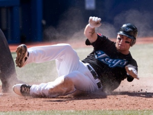 Toronto Blue Jays' Brett Lawrie scores on an RBI triple by Mike McCoy during the fourth inning baseball action against the New York Yankees in Toronto, Saturday, Sept. 17, 2011. (AP Photo/The Canadian Press, Darren Calabrese)