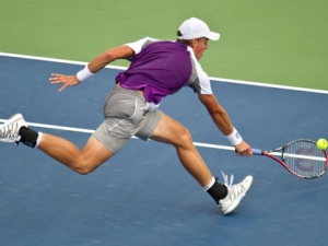 Canada's Vasek Pospisil returns to Roger Federer from Switzerland during second round of play at the Rogers Cup tennis tournament Wednesday, August 10, 2011 in Montreal. Federer won 7-5, 6-3. THE CANADIAN PRESS/Paul Chiasson