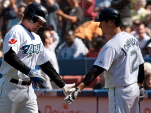 Toronto Blue Jays' Adam Lind, left, celebrates with Kelly Johnson following a solo home run in the second inning of MLB baseball action against the New York Yankees in Toronto Sunday, September 18, 2011. THE CANADIAN PRESS/Darren Calabrese