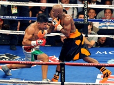 In this photo provided by the Las Vegas News Bureau, Victor Ortiz, left, battles Floyd Mayweather Jr. for the WBC welterweight championship title, Saturday, Sept. 17, 2011, in Las Vegas. (AP Photo/Las Vegas News Bureau, Brian Jones)