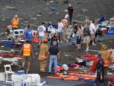 In this Sept. 16, 2011, file photo, a crowd gathers around debris after a P-51 Mustang airplane crased at the Reno Air show in Reno Nev. (AP Photo/Grass Valley Union, Tim O'Brien, File) 