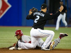 Toronto Blue Jays second baseman Kelly Johnson (2) tags out Los Angeles Angels shortstop Erick Aybar, left, after he tried to seal second base during second inning AL baseball action in Toronto on Tuesday, Sept. 20, 2011. (THE CANADIAN PRESS/Nathan Denette)