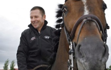 Canadian equestrian team member, Eric Lamaze, rides Hickstead while training in Spuce Meadows, Alta. (Jeff McIntosh / THE CANADIAN PRESS)