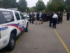 Toronto police officers gather at a command post during their search for 14-year-old Stephen Liu on Wednesday, Sept. 21, 2011. (CP24/George Lagogianes)