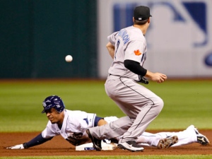 Tampa Bay Rays' Desmond Jennings slides in safely with a steal of second base as the throw gets past Toronto Blue Jays second baseman Kelly Johnson, right, during the first inning of a baseball game, Friday, Sept. 23, 2011, in St. Petersburg, Fla. (AP Photo/Mike Carlson)