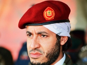 In this undated photo made available Sunday, Sept. 25, 2011, al-Saadi Gadhafi, son of Libyan leader Moammar Gadhafi, watches a military exercise by the elite military unit commanded by his brother, Khamis, in Zlitan - 90 miles (140 kilometers) southeast of Tripoli, Libya. Moammar Gadhafi's son, al-Saadi, has denied allegations of corruption and intimidation and says an Interpol decision to put him on the equivalent of its most-wanted list is political. (AP Photo/Abdel Magid al-Fergany, File)