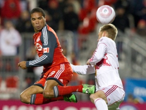 Toronto FC 's Ryan Johnson (left) battles for the ball with New York Red Bulls' Tim Ream during first half MLS action in Toronto on Saturday October 1, 2011. THE CANADIAN PRESS/Chris Young