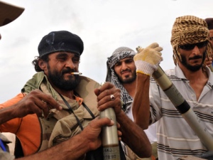 Libyan revolutionary fighters assemble missiles during an attack for the city of Sirte, Libya, Monday, Oct. 3, 2011. Rebel forces are battling to make headway against loyalist fighters inside the home town of Libya's ousted leader Moammar Gadhafi. (AP Photo / Bela Szandelszky)