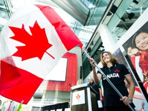 Canadian soccer player Christine Sinclair waves the Canadian flag as the Canadian Olympic Committee (COC) introduced her as the flag bearer for Canada during the opening ceremonies at the 2011 Pan American Games in Guadalajara, Mexico during a media event in Toronto, on Tuesday, Oct. 4 2011. (THE CANADIAN PRESS/Nathan Denette)