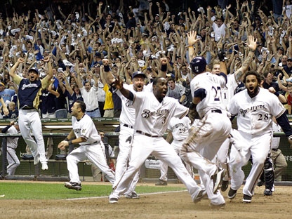 Milwaukee Brewers center fielder Carlos Gomez (27) lays down a