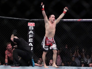 Frankie "The Answer" Edgar, right, walks away after knocking out Gray "The Bully" Maynard in the fourth round during the UFC 136 lightweight title bout, Saturday, Oct. 8, 2011, in Houston. (AP Photo/Houston Chronicle, Johnny Hanson)