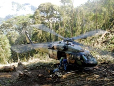 In this photo provided by the Australian Defence Force, an Australian Army Black Hawk helicopter lands at the site where an airplane crashed Tuesday and killed 13 people in the rugged mountains near Kokoda, Papua New Guinea, Friday, Aug. 14, 2009. An Airlines PNG flight carrying nine Australians, three Papua New Guineans and a Japanese was flying to the Kokoda tourist area when the plane vanished in bad weather on approach to the airport. (AP Photo/Australian Defence Force, Coporal Chris Moore)