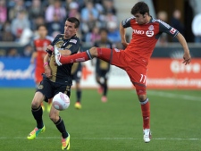 Toronto FC's Nathan Sturgis (11) collides with Philadelphia Union's Sebastien Le Toux (9) during the second half of an MLS soccer match, Saturday, Oct. 15, 2011, in Chester, Pa. The game ended in a 1-1 tie. (AP Photo/Michael Perez)