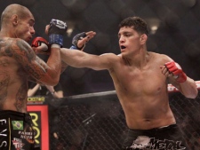 Nick Diaz, right, punches Evangelista "Cyborg" Santos, from Brazil, in the second round of a Strikeforce Welterweight Championship mixed martial arts fight in San Jose, Calif., Saturday, Jan. 29, 2011. Diaz won by submission in the second round to retain his championship. (AP Photo/Jeff Chiu)