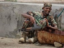 A Somali government soldier takes up a position during clashes with Islamist militants in Mogadishu, Somalia Monday, Oct. 10, 2011.(AP Photo/Farah Abdi Warsameh)