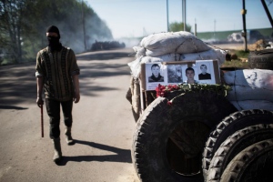 Pro-Russia gunman patrols barricade