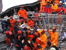 Rescue workers pull out a man from the rubble of a collapsed hotel in Van, eastern Turkey, early Thursday, Nov. 10, 2011. Rescuers have pulled out 24 survivors from the rubble of three buildings, collapsed by an earthquake in Van, the country's disaster management authority said Thursday. At least seven were killed and dozens of others trapped. The magnitude-5.7 quake was a grim replay of the previous magnitude-7.2 earthquake that hit Oct. 23, killing more than 600 people. (AP Photo )