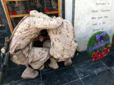 Two Canadian soldiers comfort each other as they pay their respects to a fallen comrade at the war memorial after the last Remembrance Day ceremony at Kandahar Air Field Friday, Nov. 11, 2011 in Kandahar, Afghanistan. (THE CANADIAN PRESS/Ryan Remiorz)