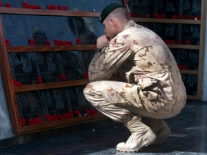 A soldier pays his respects to fallen comrades at the war memorial after the last Remembrance Day ceremony at Kandahar Air Field Friday, Nov. 11, 2011 in Kandahar, Afghanistan. (THE CANADIAN PRESS/Ryan Remiorz)