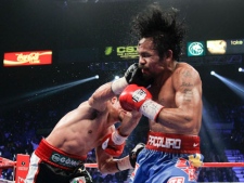 Juan Manuel Marquez, left, lands a punch against Manny Pacquiao during a WBO welterweight title fight Saturday, Nov. 12, 2011, in Las Vegas. Pacquiao won by majority decision. (AP Photo/Julie Jacobson)