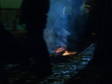 This screen grab shows a small fire burning at the site of the Occupy Toronto protest in St. James Park. Fire crews were called to the park early Monday, Nov. 14, 2011, but allowed the camp fire to continue because it is considered a "sacred fire" and is being tended to by aboriginals.