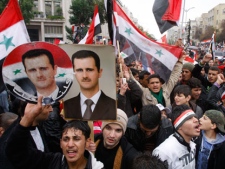 Pro-Syrian regime protesters, shout pro-Syrian President Bashar Assad slogans during a demonstration in Damascus, Syria, on Wednesday Nov. 16, 2011, during a demonstration against the Arab League meeting being held in Morocco. The Arab League is expected to formalize its weekend decision to suspend Syria from the Arab League, for failing to end its crackdown against anti-government protesters.(AP Photo/Muzaffar Salman)