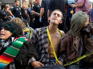 Occupy San Diego protesters form a human barrier as San Diego police officials remove tents and structures, Friday, Oct. 14, 2011. (AP / Gregory Bull)