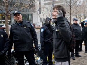 A protester reacts to police at the occupy Montreal camp as police dismantle the Occupy camp in the city's financial sector, Friday, November 25, 2011, in Montreal. THE CANADIAN PRESS/Graham Hughes