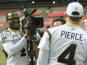 Winnipeg Blue Bombers defensive end Odell Willis, left, uses a video camera as he hams it up with Blue Bombers quarterback Buck Pierce, right, at the teams walk through during Grey Cup weekend in Vancouver B.C. on Saturday, Nov. 26, 2011.The Bombers will face off against the B.C. Lions during the the 99th Grey Cup Sunday. THE CANADIAN PRESS/Nathan Denette