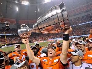 B.C. Lions quarterback Travis Lulay hoists the Grey Cup after beating the Winnipeg Blue Bombers 34-23 in the 99th CFL Grey Cup Sunday November 27, 2011 in Vancouver. THE CANADIAN PRESS/Nathan Denette