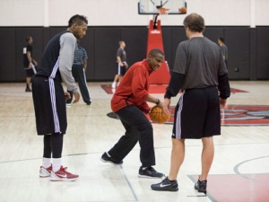 Toronto Raptor James Johnson, left, gets some advice from head coach Dwane Casey, center, and an assistant coach during a team practice at the Air Canada Center in Toronto on Friday, December 9, 2011. THE CANADIAN PRESS/Pawel Dwulit