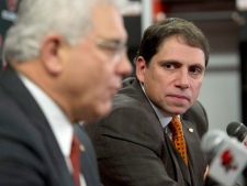 Newly appointed head coach of the BC Lions Mike Benevides listens in on BC Lions General Manager Wally Buono during a press conference at the team's practice facility in Surrey, B.C., on Tuesday, Dec. 13, 2011. (THE CANADIAN PRESS/Richard Lam)