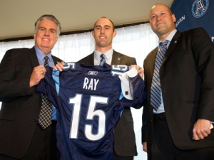 Toronto Argonauts new quarterback Ricky Ray (centre) poses with GM Jim Barker (left) and head coach Scott Milanovich at a news conference to introduce him in Toronto on Tuesday December 14, 2011. The veteran quarterback says he was shocked when told by the Edmonton Eskimos he had been dealt to Toronto. THE CANADIAN PRESS/Frank Gunn