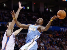 Denver Nuggets forward Gary Forbes, right, is fouled on the way to the basket by Oklahoma City Thunder center Nenad Krstic, left, in the first half of a NBA basketball game in Oklahoma City, Saturday, Dec. 25, 2010. (AP Photo/Alonzo Adams)